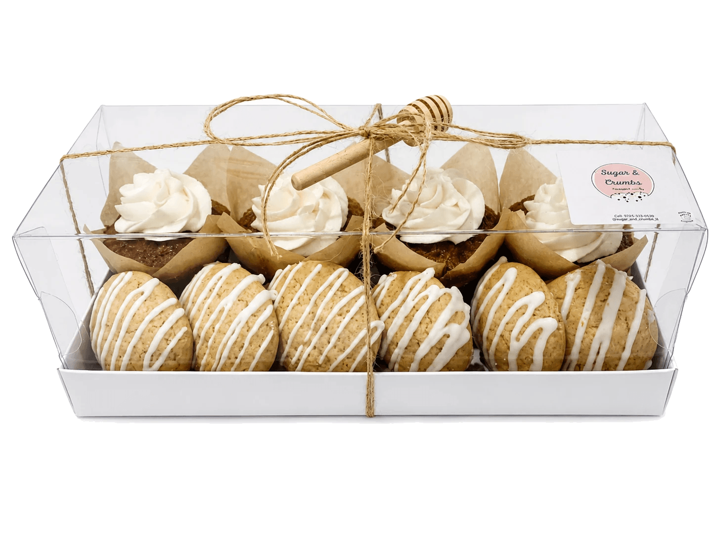 A Sugar and Crumbs celebration box with cupcakes and glazed cookies