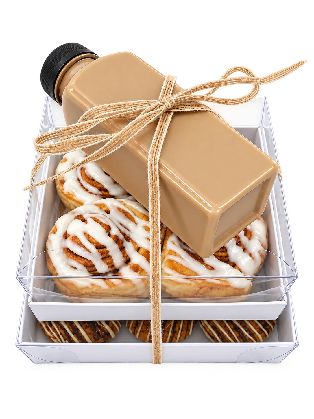 Stacked Sugar and Crumbs gift boxes of cinnamon buns, cookies and bottled iced coffee ready to send to seminary