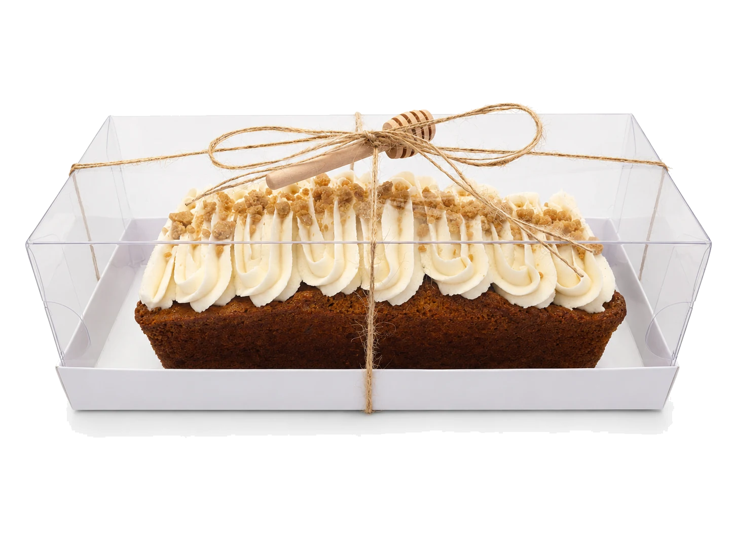 Honey cream log cake packaged with twine and a wooden honey dipper